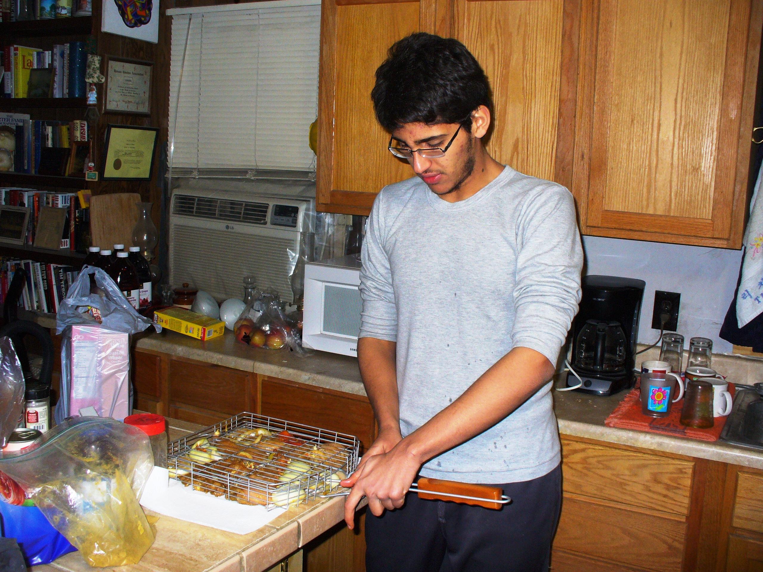 Fayez cooking in the kitchen.